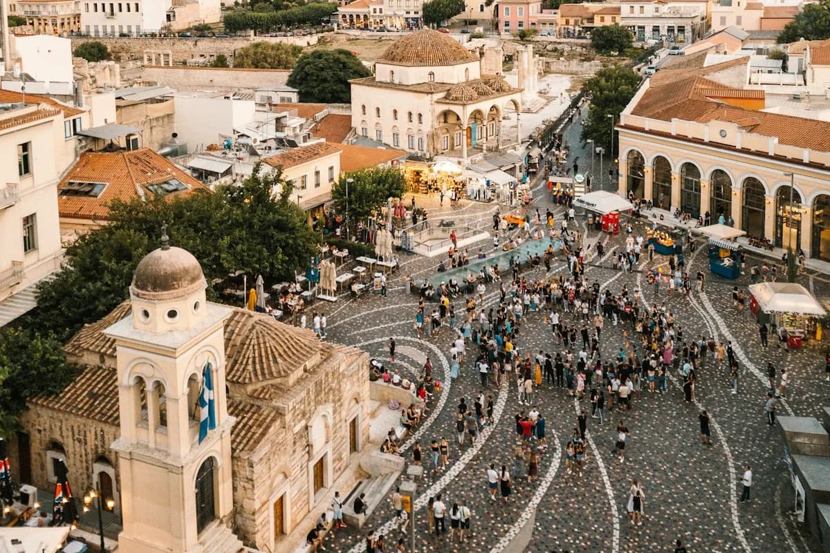 Crowds in Monastiraki Square among historic Athens buildings