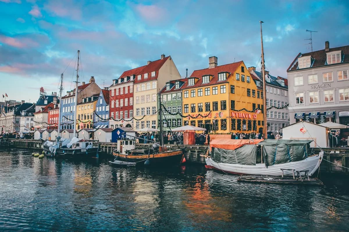Sailing boats beside colorful houses on Copenhagen’s Nyhavn canal