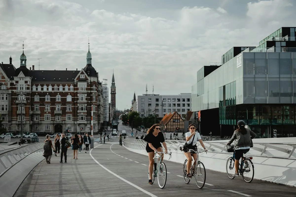 People cycling and walking across a Copenhagen bridge