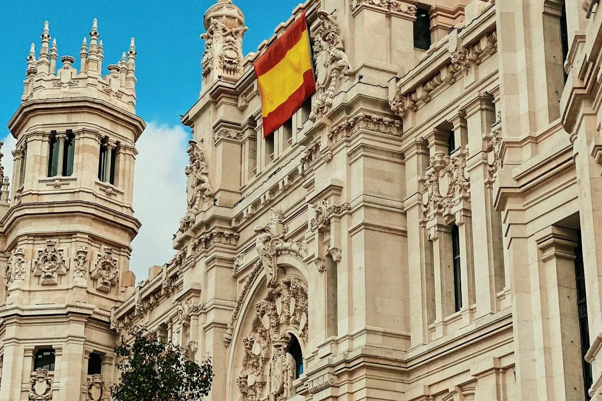 Spanish flag and carved stone facade on a central Madrid building