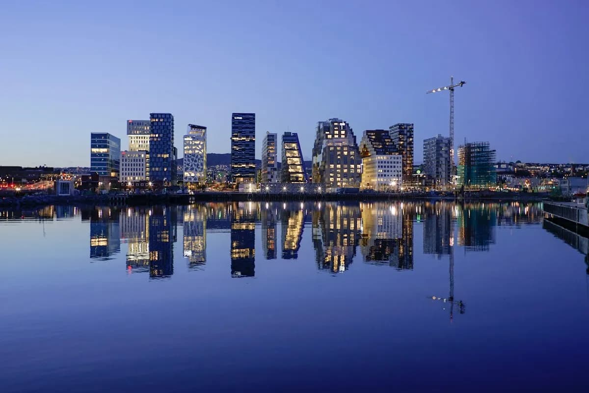 Oslo’s Barcode buildings reflected in the waterfront at dusk