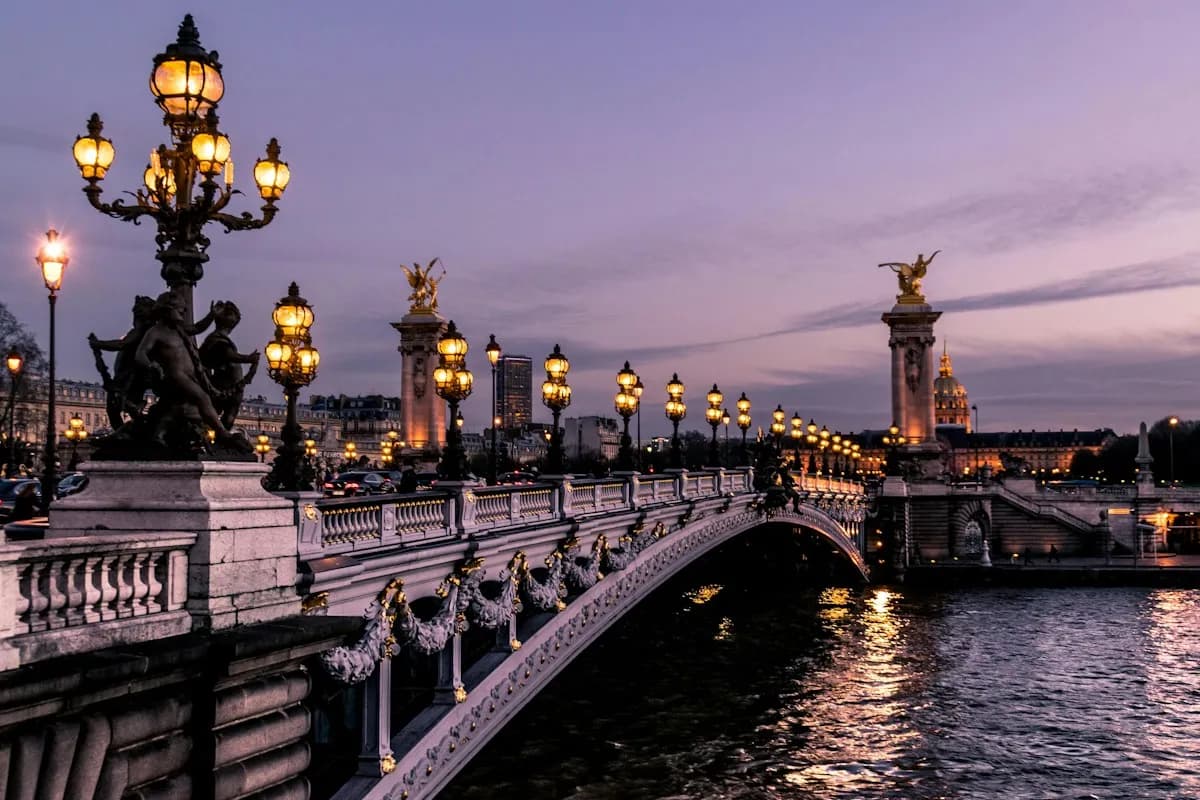 Lamps lining Pont Alexandre III beside the Seine in Paris at dusk